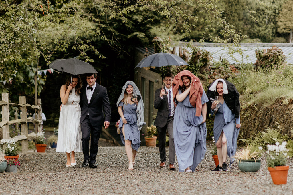 Bridal party walking in the rain